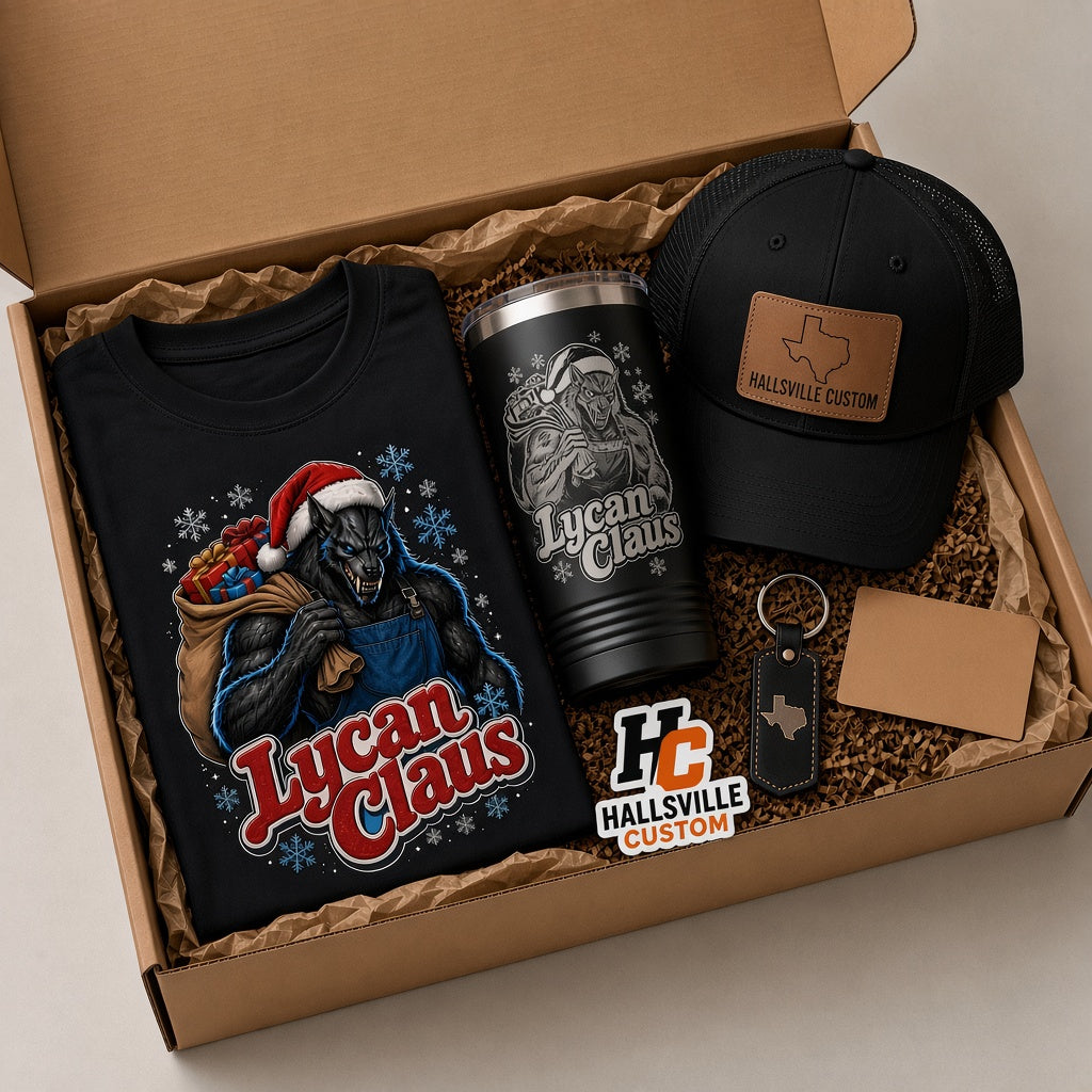 Lycan Claus Pack Leader holiday gift box with a black werewolf Santa tee, engraved black 20 oz tumbler, trucker hat with Texas leather patch, keychain and sticker